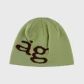 Detailed view of the sage green knit beanie featuring a distinct brown ag letter knit pattern. - Light Green