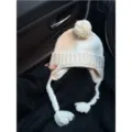 Cozy white knit beanie with earflaps and pom pom, winter warm braided tassel cap for women - Off White