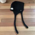 Black knitted balaclava hat with long ear flaps, warm and stylish winter accessory. - One Size / Black