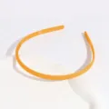 Detailed shot of orange frosted plastic headband with anti-slip teeth, simple design - Regular Fit / Turmeric