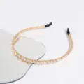Detailed view of the elegant gold pearl and pink crystal headband, delicate rhinestone hair accessory. - Pink