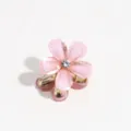 Detailed close-up of the mini pink flower hair claw clip, featuring sparkling details. - Light Pink