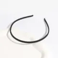 Black thin plastic headband with teeth detail close-up view, solid color matte hair accessory. - Narrow Edge / Black