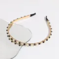 Detailed view of the Korean style gold-tone chain headband decorated with pearls and black beads. - Black