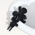 Close-up detail of the matte black butterfly hair claw clip showcasing fine texture and design. - Matte Black