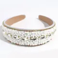 Detailed view of wide white beaded headband with sparkling rhinestones and colorful gemstone trim. - White Bead Rhinestone Style