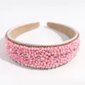 Close up of the wide pink beaded headband with sparkling rhinestones and colorful gemstone accents. - Pink Bead Rhinestone Style