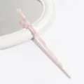 Closeup detail of a pink marbled acetate hair stick, elegant minimalist hair accessory. - Pink White