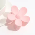 Detail view of the cute matte pink floral claw clip, highlighting its smooth frosted finish. - Light Pink
