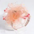 Detail view of elegant peach fascinator headband with mesh, flowers, and delicate pearls. - Orange Pink Floral Veil