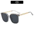 Occhiali da sole oversize da donna alla moda con aste a catena in metallo e montatura trasparente. - Montatura Grigia Trasparente
