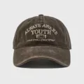 Close-up of vintage washed cotton baseball cap with detailed front embroidery lettering. - Adjustable / Coffee