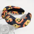 Close-up detail of a dark Halloween pumpkin printed knotted headband, black and orange. - Black and Yellow Pumpkin