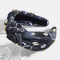 Black knotted rhinestone headband detail, featuring elegant spiderweb and skull print. - Black Spider Web Basket