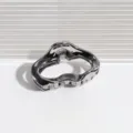 Close-up of the metallic grey hair claw clip showing smooth wavy curved edges and teeth. - Cloud Hair Claw / Cloud Dark Gray