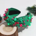 Detailed view of green knotted headband decorated with red and green pearls and rhinestones. - Pearl Rhinestone Green