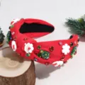 Detail view of red christmas knotted headband with rhinestone, santa and tree ornaments. - Santa Claus Red