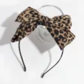 Leopard print bow headband detail shot, showing vintage retro style fabric and slim black band. - Leopard Print