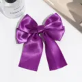 Purple satin bow hair clip with elegant streaming ribbons, perfect for vintage styling and daily wear. - Deep purple