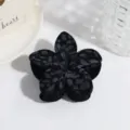 Detail view of the black flocked flower hair claw clip featuring a stylish leopard pattern texture. - Lily Leopard Pattern / Black Lily