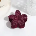 Close-up detail shot of a dark red velvet flower hair claw clip with a stylish leopard pattern. - Lily Leopard Pattern / Wine Red Frangipani