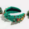 Close-up detail of the green knotted Christmas rhinestone headband with multi-color jewels. - Rhinestone Floral Green