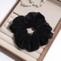 Black velvet hair scrunchie close-up view, elegant daily hair accessory for ponytails. - Black