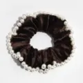 Brown velvet hair scrunchie with elegant faux pearl rim detail, close-up product view. - Coffee