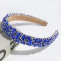 Detailed close-up of luxury Baroque blue crystal padded rhinestone headband accessory. - Blue