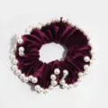 Detailed view of deep purple velvet hair scrunchie adorned with elegant faux pearls. - Fuschia