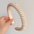 Vue détaillée du serre-tête rembourré en strass, élégant accessoire de luxe brillant. - Strass à Perles Blanc