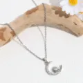Detail shot of exquisite silver moon and sun pendant necklace with sparkling cubic zirconia. - Silver Moon Star