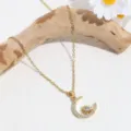 Gold rhinestone sun and moon pendant necklace detail shot showcasing delicate chain and sparkle. - Gold Moon Star
