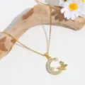 Close-up detail of the elegant gold moon and butterfly rhinestone pendant necklace. - Moon Butterfly