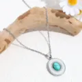 Stunning turquoise pendant necklace featuring sparkling rhinestones on a delicate silver chain. - Silver Round Turquoise
