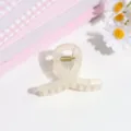 Detail of minimalist translucent hair claw clip, elegant accessory for half-up styles. - Translucent Beige