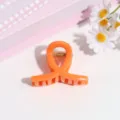 Orange sweet small hair claw clip detail shot, cute minimalist hair styling accessory. - Orange