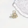 Close-up detail of the elegant alloy hair claw clip with rhinestones and star charm. - 3cm / Rhinestone Planet Shape