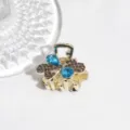 Close-up detail of the elegant rhinestone hair claw clip, sparkling blue crystals and clear stones. - Blue Rhinestone