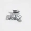 Close-up detail of a stylish silver wavy hair claw clip, compact design for daily styling. - Wave Style / S / Silver