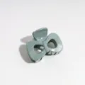 Detailed view of a stylish Morandi green bow hair claw clip with silver speckles, perfect for use. - Bow / Grey Green