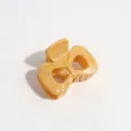 Detailed view of the yellow bow hair claw clip featuring stylish silver paint splatter pattern. - Bow / Yellow