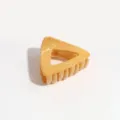 Triangle hair claw clip detail shot, yellow with silver speckles, secure ponytail hair accessory. - Triangle / Yellow