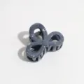 Close-up detail of a dark greyish-blue bow hair claw clip with white paint speckles texture. - Small Bowknot / Dark Gray