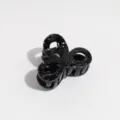 Detailed shot of the black bow hair claw with white speckles, ideal for half-up hairstyles. - Small Bowknot / Black