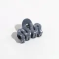 Close-up view of grey abstract wave hair claw clip, stylish daily hair accessory. - Wave / Dark Gray