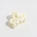 Detail shot of irregular wavy hair claw clip in off-white with silver splatter design. - Wave / White