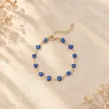 Detailed view of Turkish Evil Eye bracelet with blue beads on a linen background - Dark Blue KC Gold