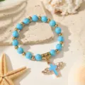 Handgefertigtes himmelblaues Perlen-Rosenkranz-Armband mit goldenem Flügelkreuz-Anhänger - Doppelter Flügel-Kreuz-Stil / Blau (ZJ17280)