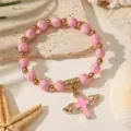 Elegante pulsera de cuentas rosas y doradas con colgante de cruz alada para bautizos - Rosa (ZJ17282)